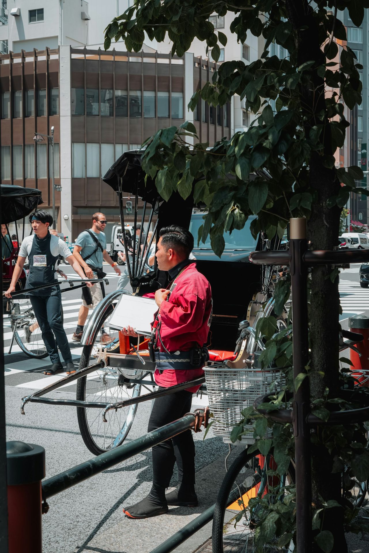 a man standing next to a bike on a city street